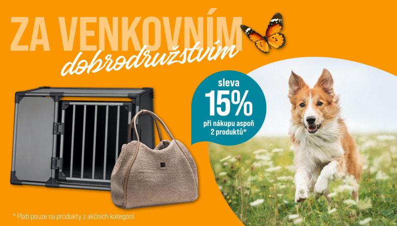 Sleva 15 % při koupi alespoň dvou produktů Pes běží po louce s bílými květy. Vlevo jsou dva produkty: cestovní taška pro psy a kovová přepravní klec. Na oranžovém pozadí je text o 15% slevě při koupi dvou produktů.